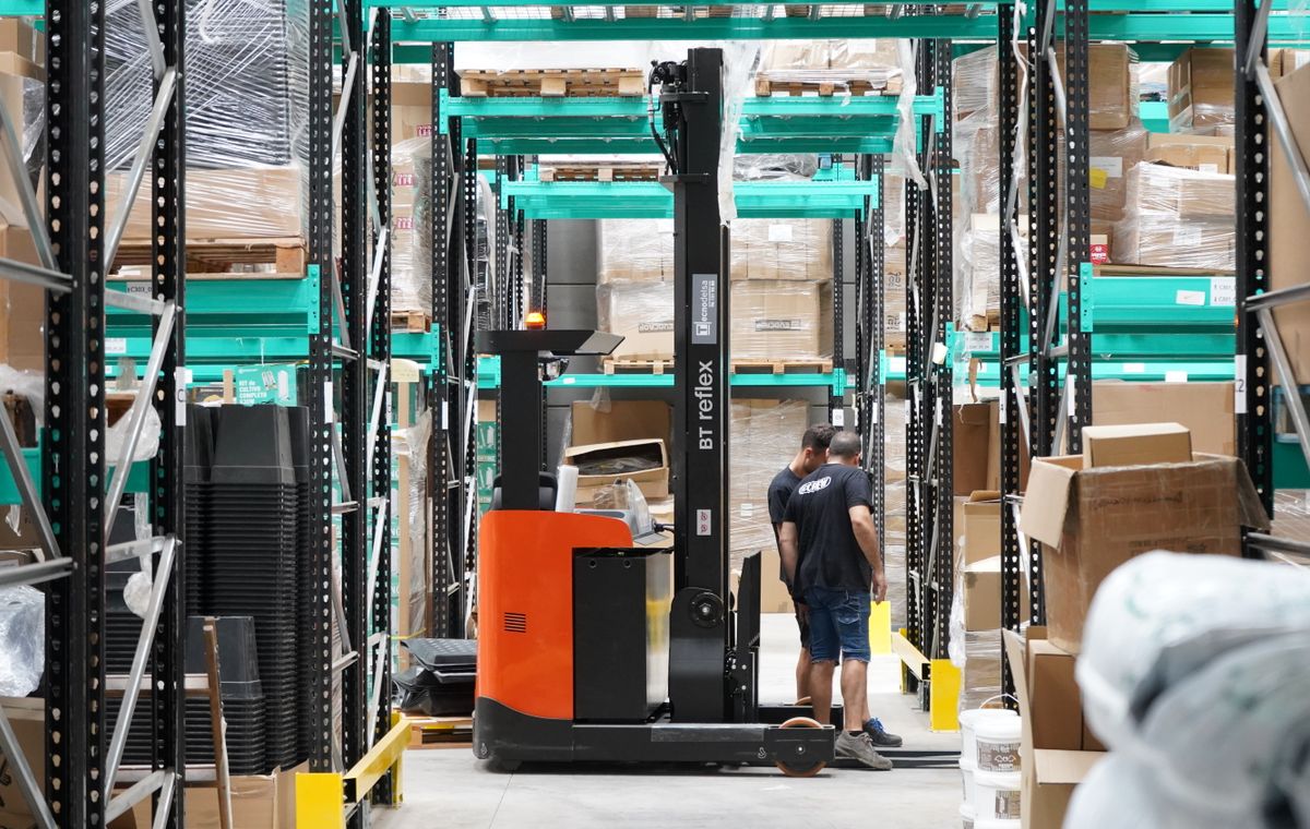 Warehouse operator handling inventory with a forklift